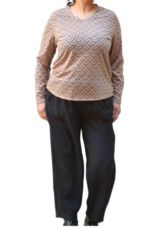 Beige stretch blouse with black scale print and V-neckline, long sleeves, styled with black trousers - plus size